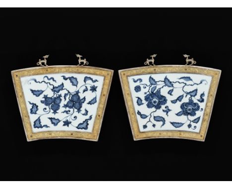 A PAIR OF 'POMEGRANATE' AND 'CAMELLIA' PORCELAIN PLAQUES IN PARCEL-GILT SILVER FRAMES, MING DYNASTYChina, the porcelain 15th 