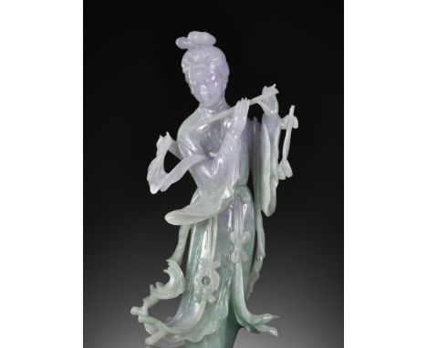 A LAVENDER AND APPLE-GREEN JADEITE FIGURE OF A BEAUTY PLAYING THE FLUTE, LATE QING DYNASTY TO REPUBLIC PERIODExpert's note: T