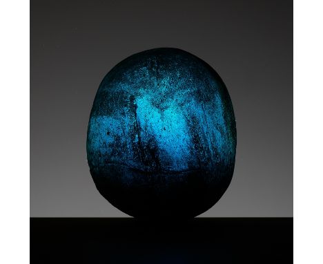 A TRANSLUCENT AQUAMARINE GLASS 'COSMIC EGG', HAN DYNASTYChina, 202 BC to 220 AD. The ritual object of ovoid form, the deep-bl