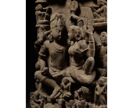 A SANDSTONE STELE OF UMA MAHESHVARA, CENTRAL INDIA, 11TH-12TH CENTURYUma-Maheshvara represents the sacred embrace, alingana, 