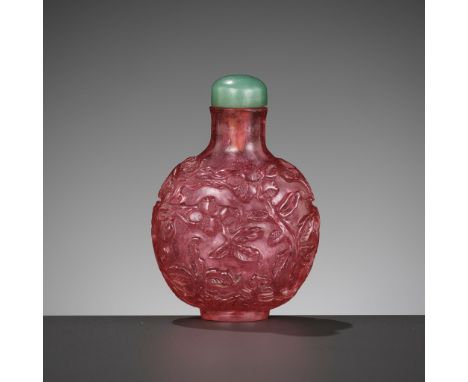 A TOURMALINE GLASS 'POMEGRANATES AND PEACHES' SNUFF BOTTLE, 1760-1840China. Of compressed globular form, rising from a small 