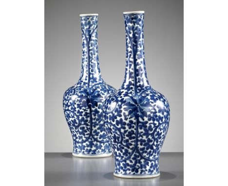 A PAIR OF BLUE AND WHITE 'LOTUS' MALLET VASES, KANGXI PERIODChina, 1662-1722. Rising from a splayed foot to a broad rounded s