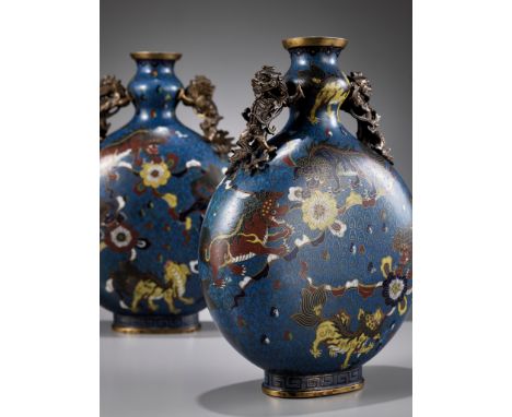 A RARE PAIR OF CLOISONNE ENAMEL 'BUDDHIST LION' MOON FLASKS, BIANHU, 19TH CENTURYChina. Each with a flattened globular body d