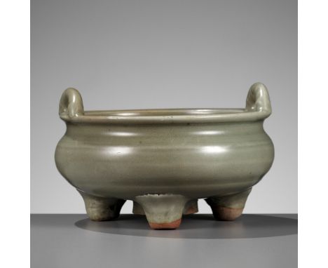 A LONGQUAN CELADON TRIPOD CENSER, MING DYNASTYChina, 15th-16th century. Of compressed globular form rising from three sturdy 