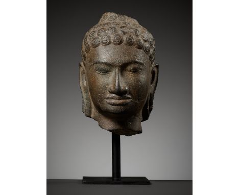 A SANDSTONE HEAD OF BUDDHA SHAKYAMUNI, MON-DVARAVATI PERIODThailand, 8th-10th century. Sensitively carved with heavy-lidded d