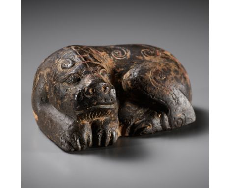 A LIMESTONE 'LION' MAT WEIGHT, HAN DYNASTYChina, 206 BC to 220 AD. Carved as a recumbent lion with its feet tucked underneath