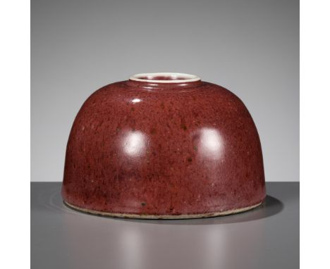 A PEACHBLOOM-GLAZED 'BEEHIVE' WATERPOT, 19TH CENTURYChina. The domed body with short waisted neck and slightly everted rim, t