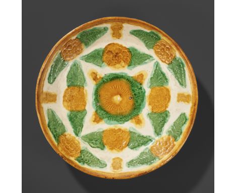 A SANCAI-GLAZED 'FLORAL' DISH, LIAO DYNASTYChina, 907-1125. Well potted with shallow sides rising from a short foot, the inte