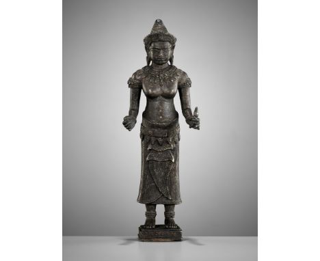 A BRONZE FIGURE OF THE GODDESS UMA, KHMER, ANGKOR WAT STYLE, 12TH - 13TH CENTURYUma is standing upon a simple square plinth w