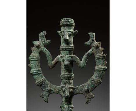 A LURISTAN BRONZE 'MASTER OF ANIMALS' STANDARD FINIAL, IRAN, CIRCA 1000-650 BCThe tubular base surmounted by a stylized janus