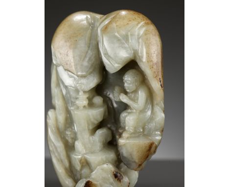 A CELADON AND RUSSET JADE 'LUOHAN IN A GROTTO' BOULDER, 17TH - 18TH CENTURYChina. Deeply carved to depict a luohan with a boo