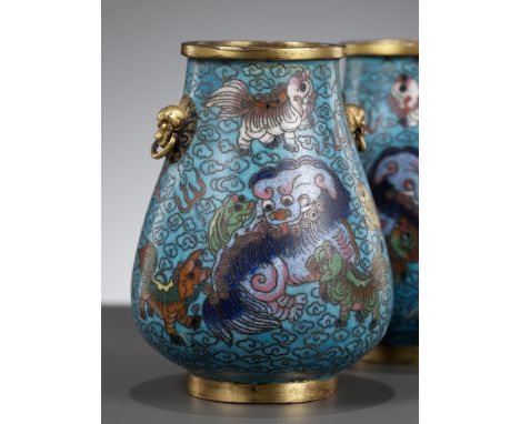 A PAIR OF CLOISONNE ENAMEL MINIATURE 'BUDDHIST LION' VASES, HU, QING DYNASTYChina, 1644-1912. Each with a pear-shaped body su