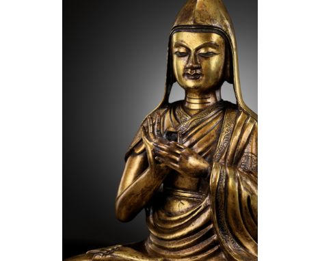 A LARGE GILT BRONZE FIGURE OF TSONGKHAPA, 17TH-18TH CENTURYTibetan-Chinese. The heavily cast figure weighs over 6 kilograms a
