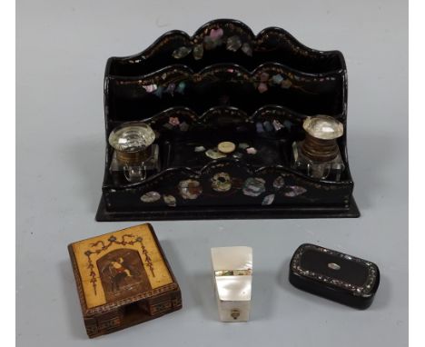 A VICTORIAN PAPIER MACHE STATIONARY RACK, having shaped top rail with two division letter rack over central lidded compartmen
