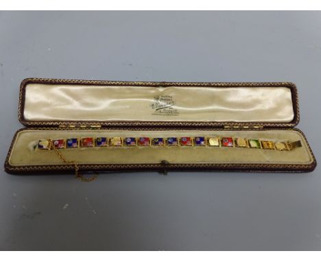 YELLOW METAL FLAGS OF THE WORLD ENAMELLED BRACELET, composed of eighteen enamel panel links with flag pole detail, depicting 
