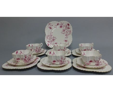 A FOLEY CHINA WILEMAN & CO SHELLEY PART TEA SERVICE, decorated in puce honeysuckle pattern, comprising six trios and bread an