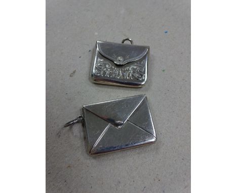 TWO SILVER STAMP CASES, both in the form of envelopes, the plain example stamped sterling silver, the other embossed 'Stamps'