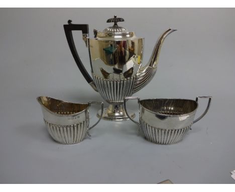 A MATCHED SILVER THREE PIECE COFFEE SERVICE, with half reeded decoration, coffee pot having ebonised handle and finial, coffe