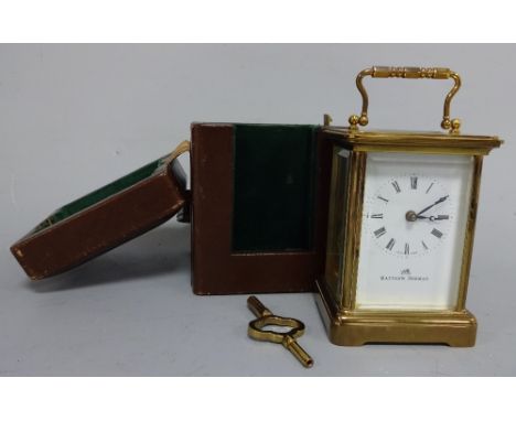 A CASED GILT BRASS CARRIAGE CLOCK, white enamelled dial having Arabic numeral chapter ring inscribed Matthew Norman, impresse