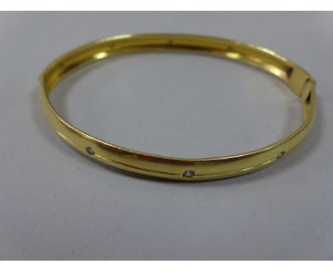 A DIAMOND BANGLE, with interspaced brilliant-cut diamonds to the D-shape band, diameter 6.8cm, approximate weight 22g