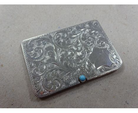 A SILVER RECTANGULAR STAMP CASE, having turquoise stone button to sliding two division interior with engraved scroll decorati