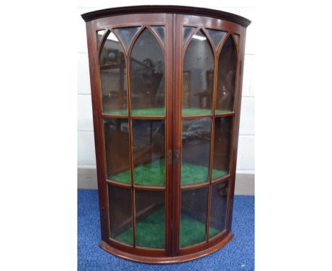 A 19TH CENTURY MAHOGANY INLAID BARREL FRONT GLAZED CORNER CABINET, with string inlaid doors to three shelf interior, approxim