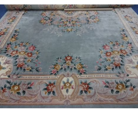 A LARGE GREEN GROUND CARPET, having floral and foliate decoration, approximately 686cm x 368cm