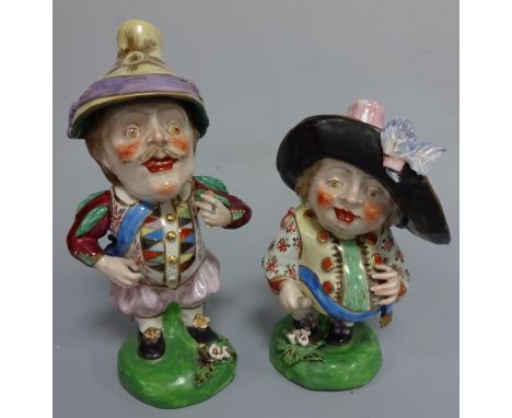 TWO DERBY STYLE MANSION HOUSE DWARVES, each wearing oversized hats, decorated in typical style set on green bases with floral