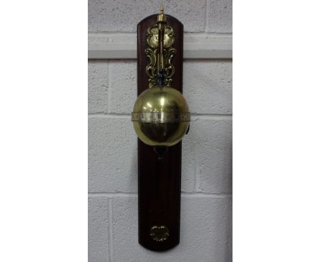 A THWAITES REED GRAVITY CLOCK, having suspended brass globe with silvered Roman and Arabic equatorial ring on scrolled brass 