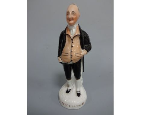 A STAFFORDSHIRE FIGURE, Jimmy Wood wearing tailed jacket and breeches with pink waistcoat, stood before tree stump, having co