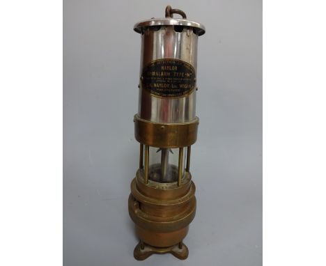 A NAYLOR SPIRALARM TYPE 'M' BRASS MINERS LAMP, with red glass to base, approximately 30cm high