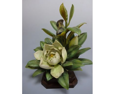 A ROYAL WORCESTER MAGNOLIA WARBLER, Dendroica Magnolia by D. Doughty, on stepped wooden plinth, approximately 40cm cm high (a