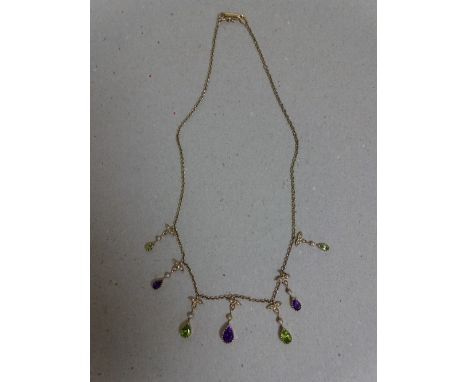 A 9CT NEGLIGEE PERIDOT, AMETHYST AND SEED PEARL PENDANT