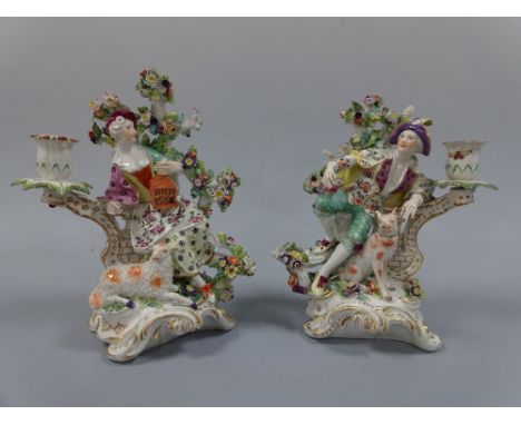 A PAIR OF 18TH CENTURY DERBY CANDLESTICKS, Liberty and Matrimony, modelled as gent leaning on wall before floral bocage with 