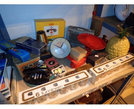 Shelf of retro items mainly unused radio clocks iron timers etc 