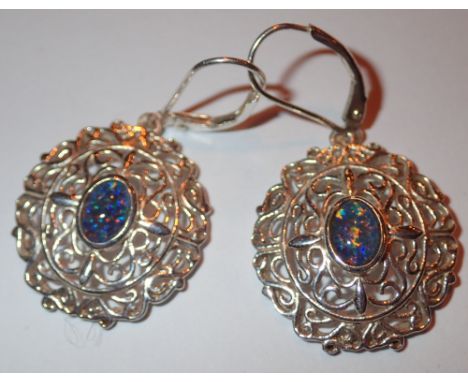 Previously owned but unused silver circular drop earring set with opal dublets