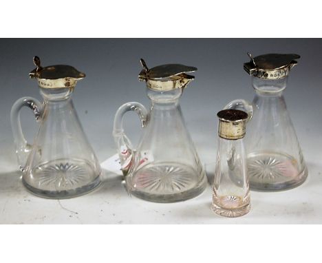 A set of three Edwardian whisky tots, each having conical glass bodies with star-cut bases and silver mounts, maker Hukin & H