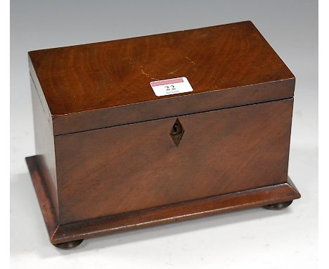 A Victorian walnut tea caddy, of plain rectangular form, the hinged lid opening to reveal twin compartment interior, raised o