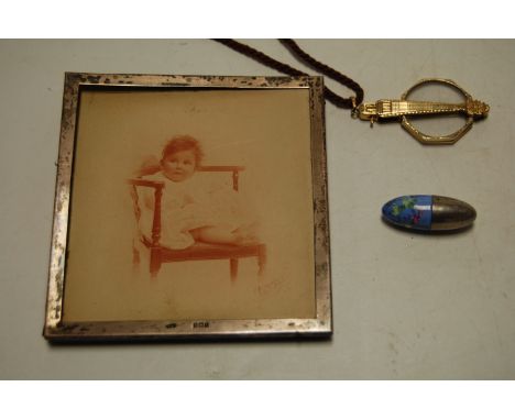 An Edwardian silver clad photograph frame of plain square form together with an early 20th century yellow metal lorgnette, an