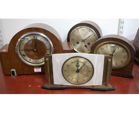 An Art Deco walnut cased mantel clock, having silvered chapter ring with Roman numerals, eight day movement striking on a gon