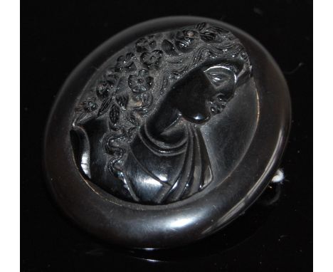 A Victorian carved Whitby jet cameo brooch, depicting profile portrait of a maiden with flowers in her hair, 5.8 x 5cm