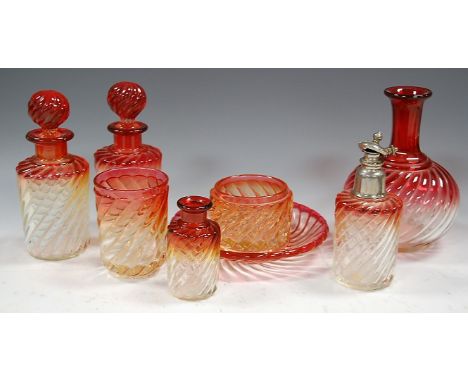 A collection of assorted early 20th century Baccarat cranberry tinted swirled glass tablewares, to include; pair of decanters