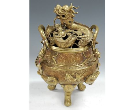 A Chinese bronzed koro and cover, the cover in the form of a sinuous dragon, the body having twin dragon handles with Greek K