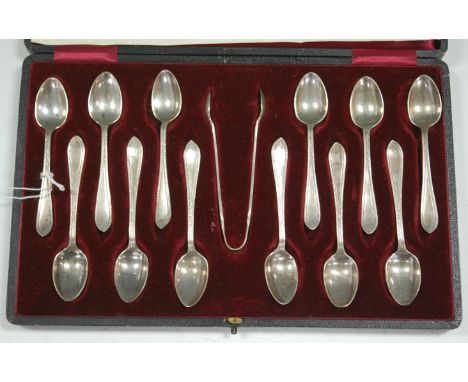 A set of twelve George V silver teaspoons, with matching sugar tongs, in fitted red velvet lined leather case, maker Walker &