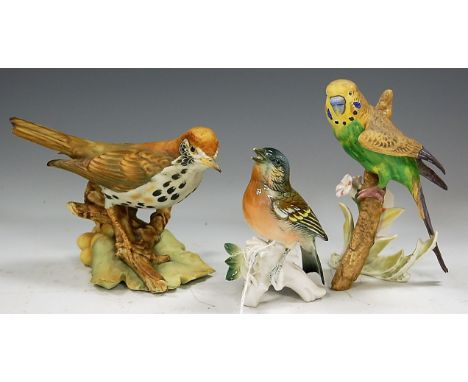 A Karl Ens porcelain figure of a finch, having printed mark verso, h.13cm; together with a Goebel figure of a budgerigar; and