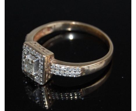 A 9ct gold diamond dress ring, arranged as a centre baguette cut diamond in a surround of diamond points, 3.5g, size T/U