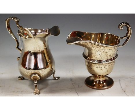 A George V silver helmet shaped cream jug, having acanthus leaf C-scroll handle, raised on padfeet, maker J B Chatterley & So