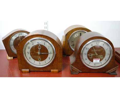 A 1930s oak cased mantel clock, having silvered chapter ring with Arabic numerals and eight day movement striking on a gong; 