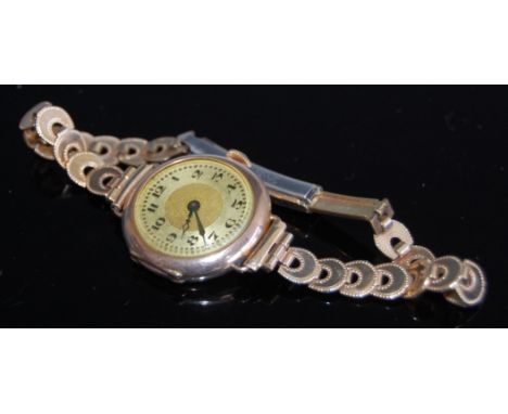 A 9ct gold cased ladies wristwatch, having manual wind movement and on gilt metal bracelet 