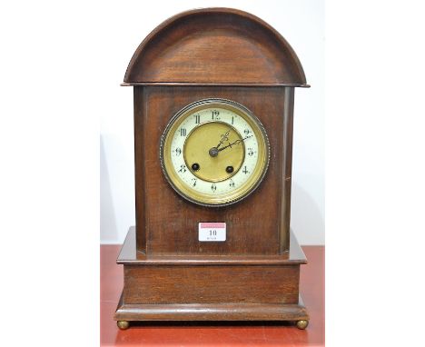 An early 20th century Continental walnut cased mantel clock, having enamelled chapter ring with Arabic numerals, eight day mo